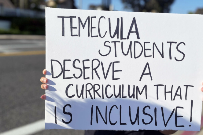 A protest sign reads TEMECULA STUDENTS DESERVE A CURRICULUM THAT IS INCLUSIVE!