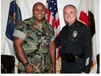 Murder suspect and former LAPD officer Christopher Jordan Dorner in an image with then-LAPD Chief Bill Bratton, in the August 2006 issue of the department's magazine BEAT.