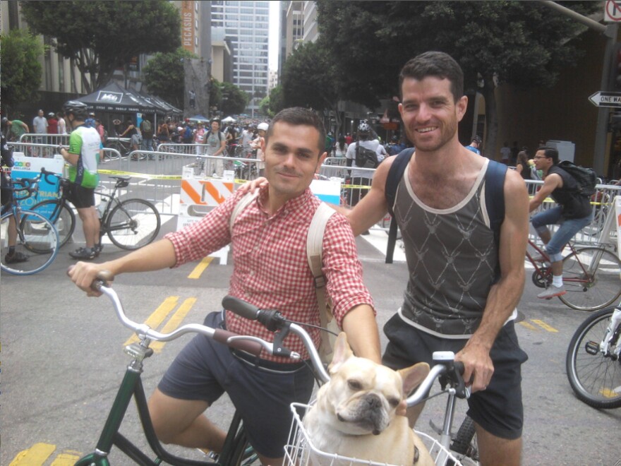 Bordeaux Martin (right) poses with his husband Alexander Santillanes (left) and their French bulldog at CicLAvia Sunday. 
