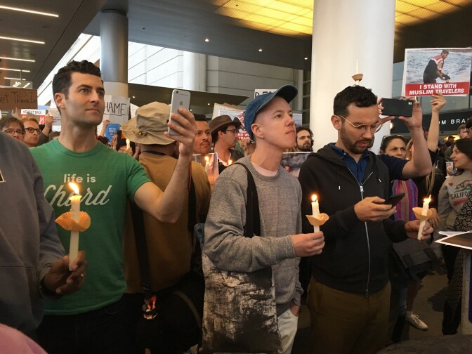 Protesters gather at the Los Angeles International Airport Saturday afternoon to express opposition to President Donald Trump's executive order suspending visas held by travelers from countries with largely Muslim populations.