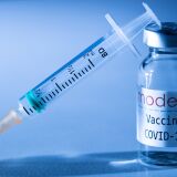 This illustration picture taken in a studio in Paris on November 16, 2020, shows a syringe and a vial with the logo of US biotech firm Moderna. - Moderna on November 16, 2020 announced its experimental vaccine against Covid-19 was almost 95 percent effective, marking a second major breakthrough in the quest to end the pandemic. (Photo by JOEL SAGET / AFP) (Photo by JOEL SAGET/AFP via Getty Images)