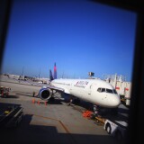 NEW YORK, NY - NOVEMBER 21: A Delta airlines plane is seen at the gate in LaGuardia Airport as passangers travel on the day before Thanksgiving on November 21, 2012 in New York, United States. The day before the Thanksgiving holiday is one of the busiest travel days of the year.  (Photo by Joe Raedle/Getty Images)