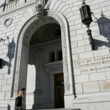 SAN FRANCISCO - JANUARY 22:  A woman walks into the State of California Earl Warren building January 22, 2007 in San Francisco, California. The U.S. Supreme court threw out California's sentencing law on Monday, a decision that could reduce sentences for thousands of inmates in the California State correctional facilities.  (Photo by Justin Sullivan/Getty Images)