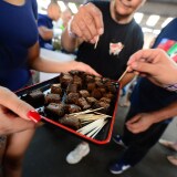 Care-carrying medical marijuana patients sample the brownies at Los Angeles' first-ever cannabis farmer's market at the West Coast Collective medical marijuana dispensary, on the fourth of July, or Independence Day, in Los Angeles, California on July 4, 2014 where organizer's of the 3-day event plan to showcase high quality cannabis from growers and vendors throughout the state. 