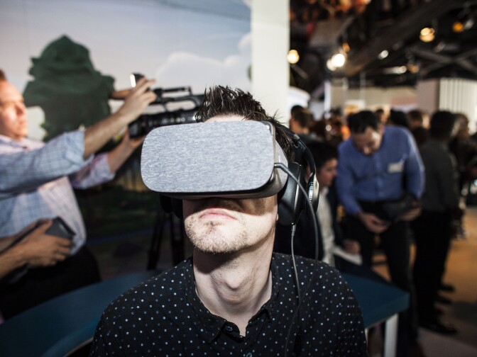 A journalist uses Google's Daydream VR headset during an event to introduce Google hardware products on October 4, 2016 in San Francisco, California. Google unveils new products  including the Google Pixel Phone making a jump into the mobile device market. 