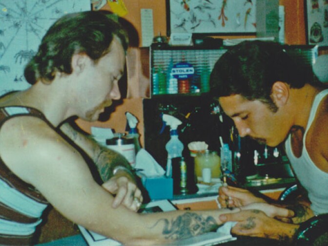 Tattoo artist Freddy Negrete tattoos fellow artist Jack Rudy in the early days of Tattooland in East LA. 