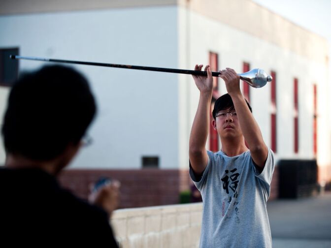 Junior Brian Kaw prepares for the Camarillo Holiday Parade, happening the next day on Saturday, Dec. 8. The assistant drum major practices in front of the old gymnasium, which was updated with bond funds.