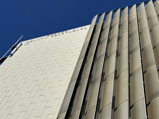 A view of a tall building from closeup and below.
