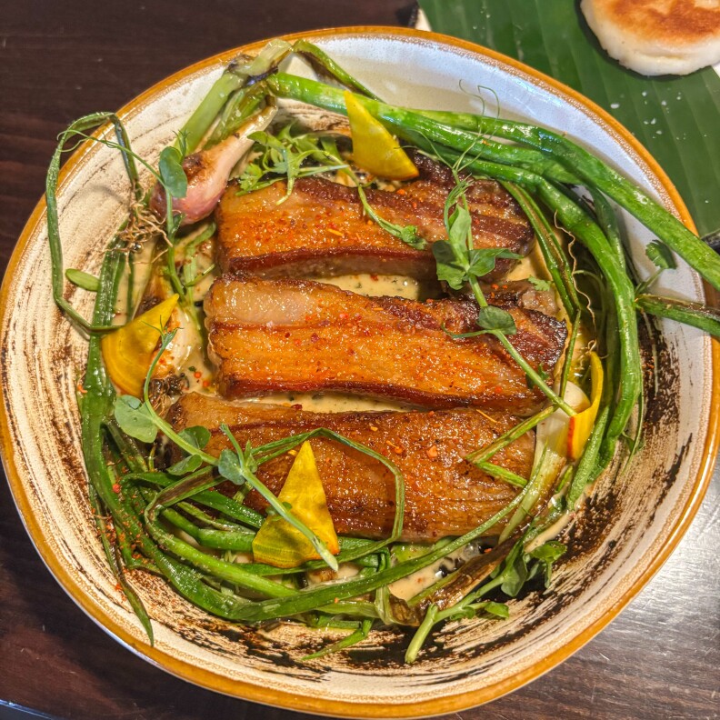 Fatty, crunchy lamb belly slabs tucked in with red spring onions and bright yellow pickled beets.