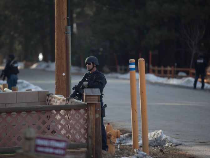 Law enforcement officials conduct a door-to-door search in Big Bear for Christopher Dorner. His truck was found burned in the area.