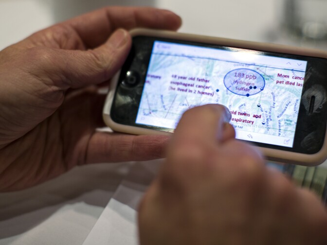 Patricia Oliver, an attorney with the R. Rex Parris Law Firm, looks at a map of active and inactive wells throughout SoCal Gas' natural gas storage facility near Porter Ranch.