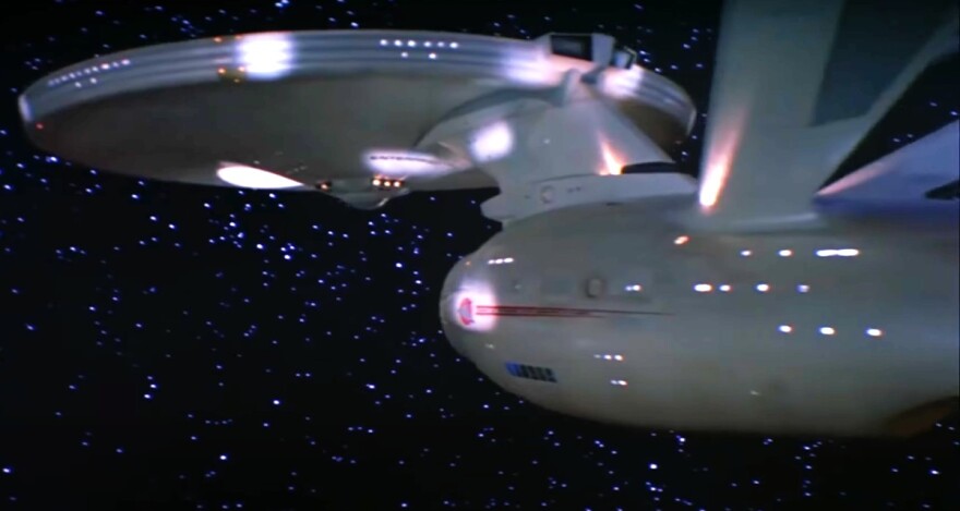 The Starship Enterprise space ship traveling in space