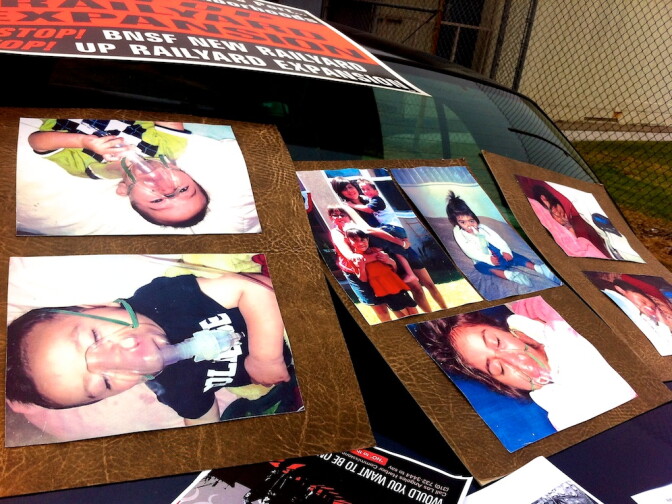 Outside Stephens Junior High School, concerned mothers, grandmothers and community residents display pictures of children with respiratory and other ailments they believe are connected to diesel pollution from locomotives. 