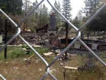 The stone chimney of the cabin where Christopher Dorner died near Big Bear is about the only thing left standing after the fire burnt the building down to its foundation.