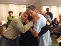 Steve Luftman (l.) hugs his partner Karen Smalley (middle) and Andrew Lavick (r.)