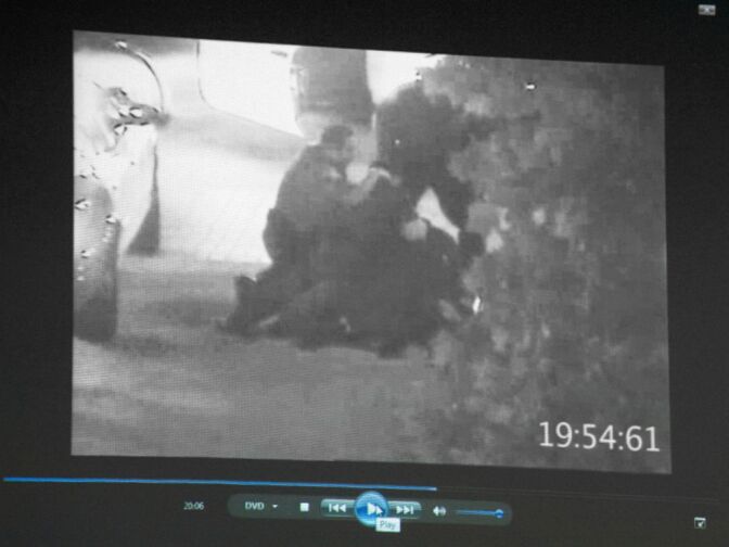 Defense attorney John D. Barnett, who is representing Fullerton police officer Manuel Ramos in the death of Kelly Thomas, a homeless man, shows video footage from a surveillance camera that captured the incident and points out at several times that Ramos is working on retraining Thomas' feet or is overseeing the altercation rather than directly participating in the chest compression some believe ultimately cut off Thomas' airflow. Here, both the defense and prosecution agree that Ramos is the officer standing on the left side of the frame.