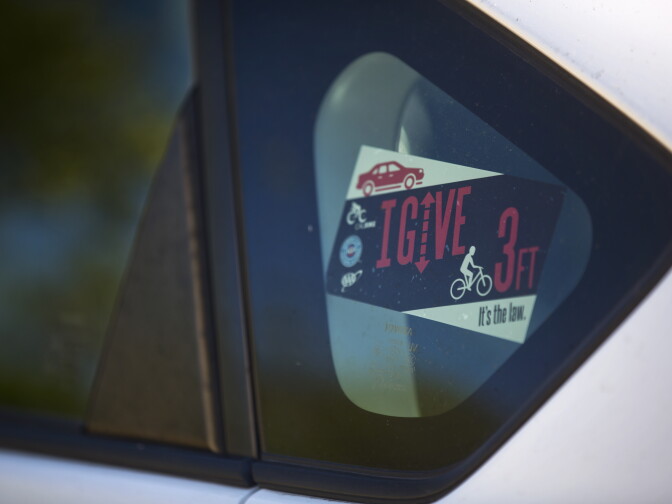 Sponsors have made bumper stickers for the Three Feet for Safety Act. Starting September 16, drivers must give cyclists at least three feet of clearance.