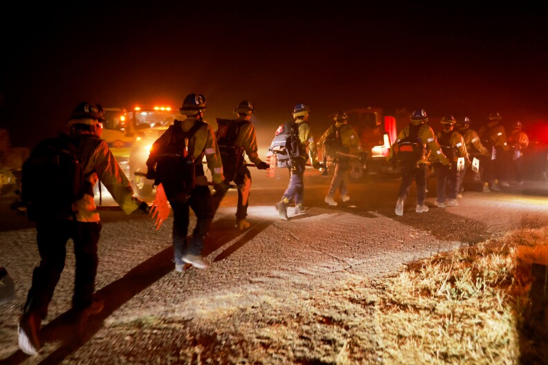 Firefighters hiking in the dark.