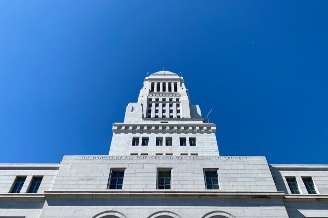 City Hall against a blue sky from the perspective of someone looking up.