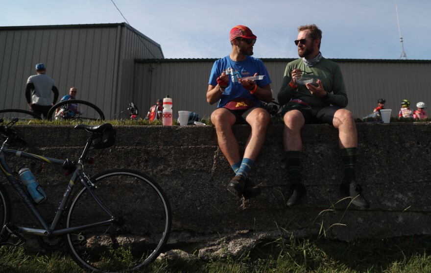 Alex Brooks of Minneapolis, Minn., (left) and Tim Connors of Robinsdale, Minn., eat slices of pie Tuesday, July 26, during a pit stop in Rolfe, Iowa. Connors said they were trying to eat a different slice of pie every day, with strawberry rhubarb, a childhood favorite, ranking as his top slice so far. "That's because the key ingredient in pie is nostalgia," Connors quipped.