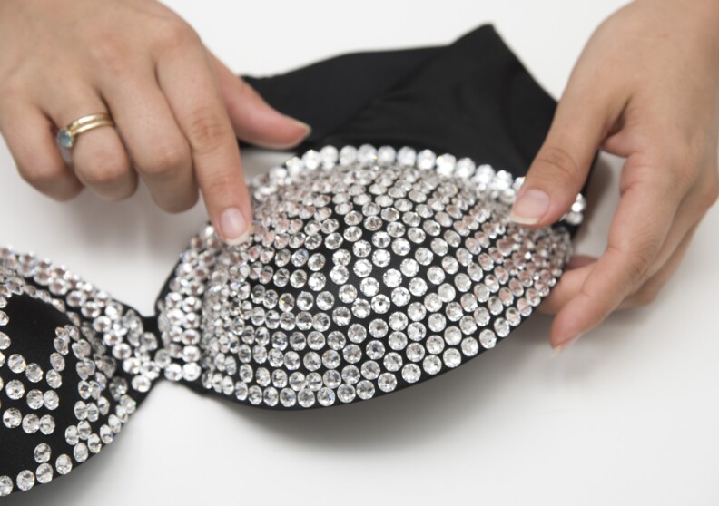 Workers in London prepare the iconic bustier for Selena's wax figure. 