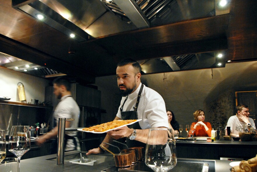 Chef Vladimir Mukhin prepares food at his Chef's Table restaurant in Moscow. Mukhin owns more than 20 restaurants, mostly in Russia, including White Rabbit.
