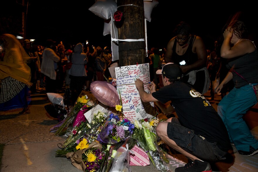 FALCON HEIGHTS, MN - JULY 07: Protestors sign a memorial at the intersection where Philando Castile was shot on July 7, 2016 in Falcon Heights, Minnesota. Castile was shot and killed by a police officer during a traffic stop on July 6, 2016.(Photo by Stephen Maturen/Getty Images)