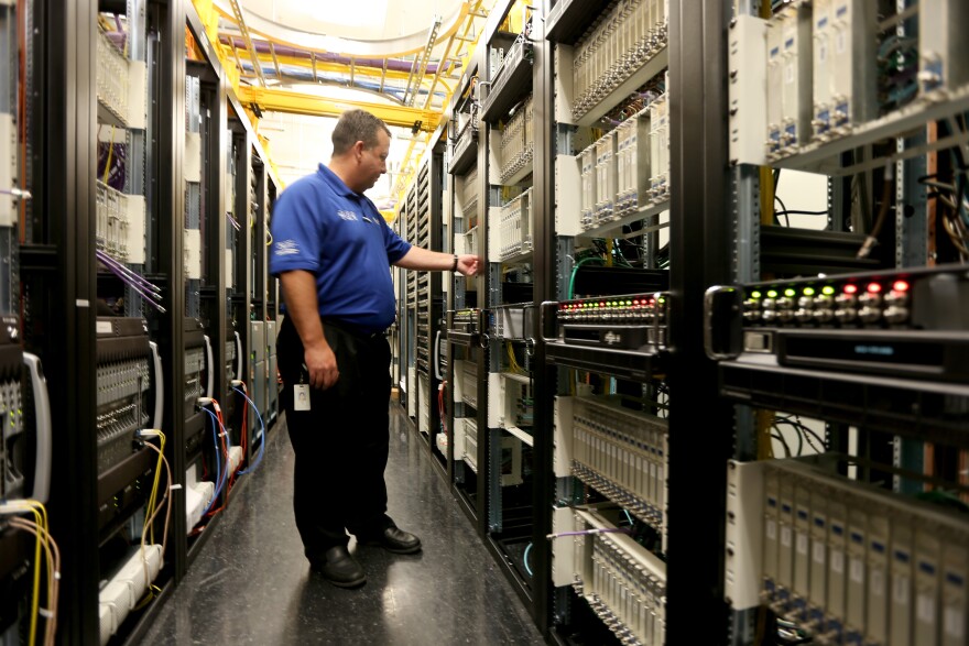 MIRAMAR, FL - FEBRUARY 13:  Brian Hunt,  Director Engineering, South Florida, stands among the cables and routers at a Comcast distribution center where the Comcast regional video, high speed data and voice are piped out to customers on February 13, 2014 in Miramar, Florida.  Today, Comcast announced a $45-billion offer for Time Warner Cable.  (Photo by Joe Raedle/Getty Images)