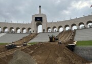Dirt and a tractor inside an open-air L.A. Colisuem 