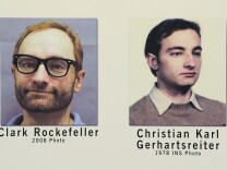 Photographs of Christian Karl Gerhartsreiter, also known as Clark Rockefeller, are seen on display during a news conference, Friday, Aug. 15, 2008 at a Federal Bureau of Investigation office in Boston. The FBI said Friday that it pulled fingerprints off decades-old immigration papers to identify the kidnapping suspect who calls himself Clark Rockefeller as a German man who came to the U.S. as a youth and later adopted several aliases. 