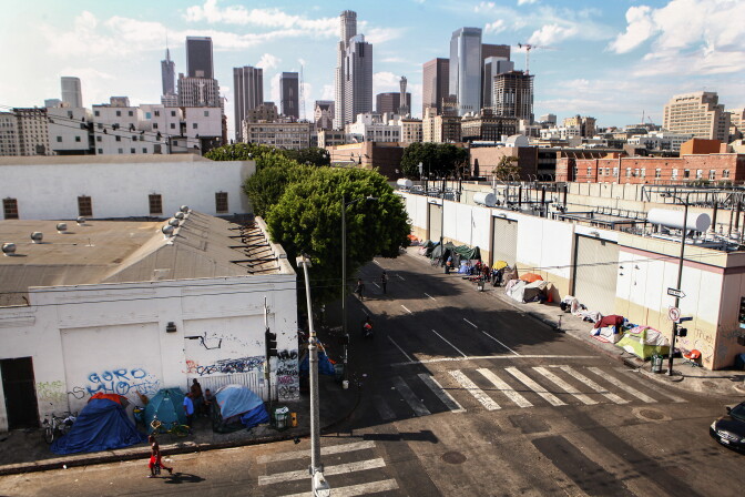 LOS ANGELES, CALIFORNIA - SEPTEMBER 16: A man walks past a homeless tent encampment in Skid Row on September 16, 2019 in Los Angeles, California. Skid Row is home to thousands who either live on the streets or in shelters. The city of Los Angeles has seen a 16 percent increase in homelessness since 2018 amidst a housing crisis. A new plan under consideration in the city would bar homeless people from sleeping on sidewalks and streets in more than 25 percent of Los Angeles. (Photo by Mario Tama/Getty Images)