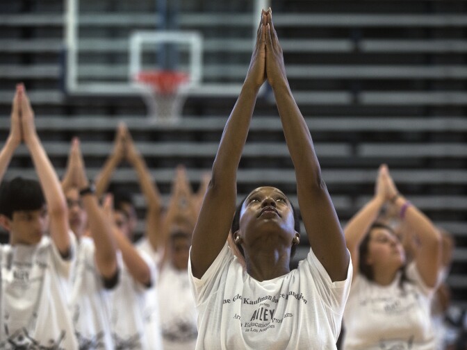 Teaching artist Ebony Ruffin takes part in leading students through the choreography for Alvin Ailey's "Revelations." The dance is based on Ailey's childhood memories of segregation and growing up during the Great Depression.