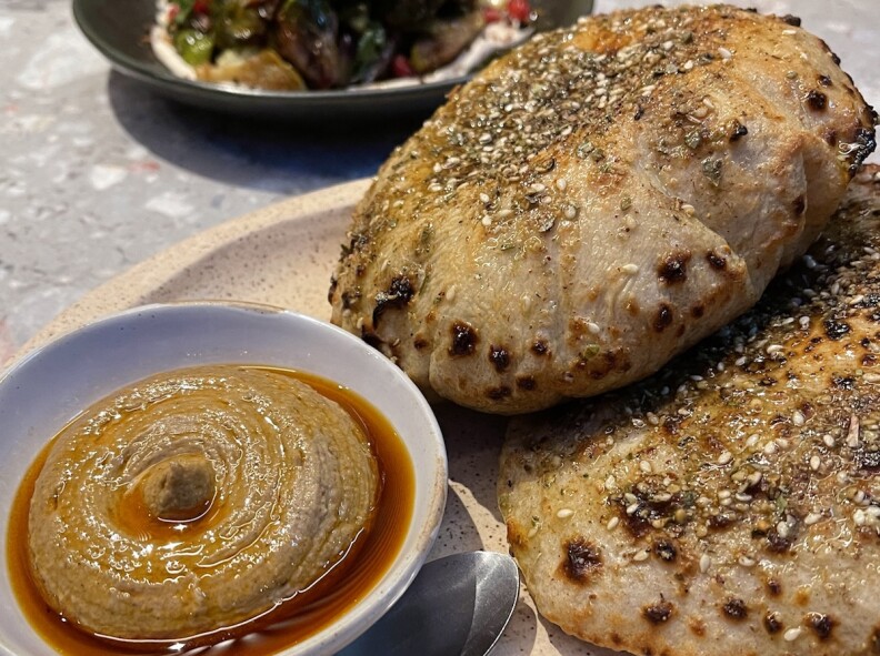 Two Sourdough Puffed Pitas with baba ghanoush, at left.