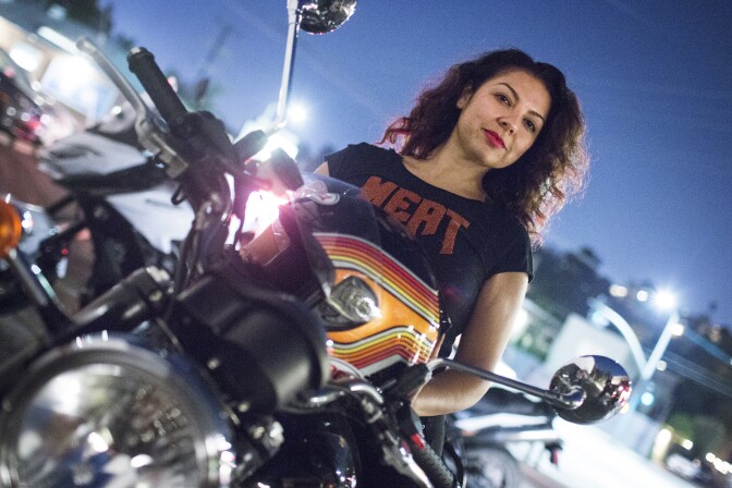 Elisa Perez is a member of the Eastside Moto Babes, a club of female motorcycle riders. Perez prepares to ride a 2015 Triumph Bonneville during the group's weekly Tuesday night ride on August 2, 2016 from the Tomato Pie Pizza Joint parking lot in Silver Lake.