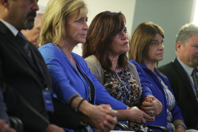 WASHINGTON, DC - APRIL 26:  Sabine Durden (C) of Mineral Spring, Arkansas, whose son Dominic Durden was killed in a traffic accident with an undocumented immigrant, holds hands with other victims' family members during a news conference April 26, 2017 in Washington, DC. Homeland Security Secretary John Kelly held a news conference to announce the opening of the new Victims of Immigration Crime Engagement (VOICE) office.  (Photo by Alex Wong/Getty Images)