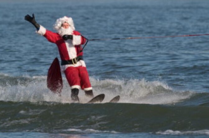 A man dressed as Santa Claus water skis on the Potomac River at National Harbor in Prince George's County, Maryland, near Washington, DC, on December 24, 2009.