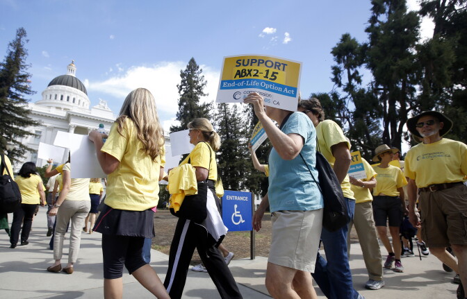Supporters of a measure to allow the terminally ill to end their own life march at the Capitol while calling on California Gov. Jerry Brown to sign the bill Thursday, Sept. 24, 2015, in Sacramento, Calif.