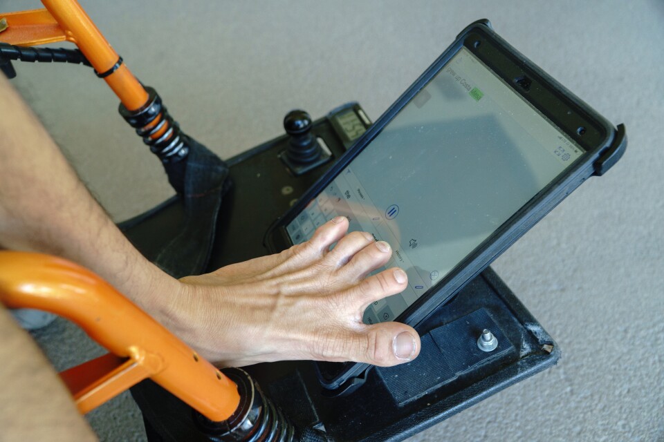 Tim Jin uses an iPad mounted to his wheelchair to type out a sentence. It's his main form of communication. 