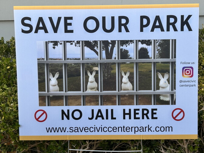 A yard sign reads 'Save Our Park, No Jail Here' with an image of rabbit statues behind bars overlaid on a park photo.
