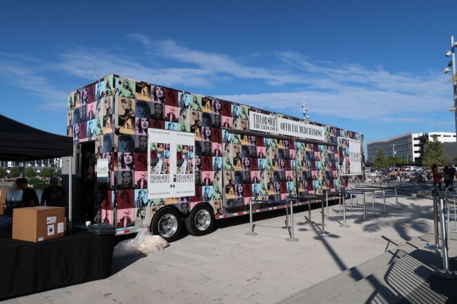 A multicolored van with portraits of Taylor Swift all over it. 