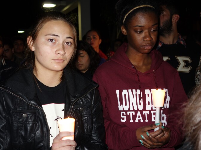 Freshmen Hannah Tsutsui, left, and Jordan Christian hold candles at a vigil for slain student Nohemi Gonzalez, who was killed in the Paris terror attacks Nov 13.