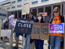  Protesters rallied on March 30, 2023 to call on L.A. County to close Men's Central Jail by March 2025. They hold signs which read: "No More Delays: Close MCJ" and "John Horton: Never Forget: Close MCJ" 