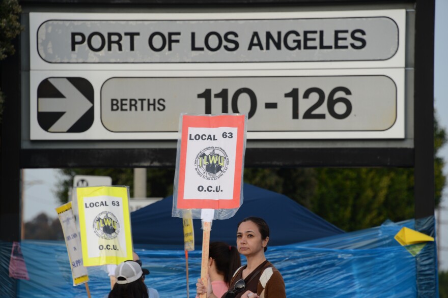 Striking workers carry placards December 4, 2012 at the Port of Los Angeles in southern California. Commerce could be brought to a near standstill at major ports from Boston to Houston if a strike takes place on Sunday, potentially delivering a big blow to retailers and manufacturers still struggling to find their footing in a weak economy.