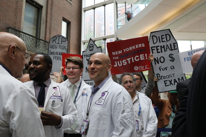 NEW YORK, NY - JUNE 23:  Doctors, nurses, patients and activists listen as Senate Minority Leader Chuck Schumer (D-NY) speaks at Bellevue Hospital a day after the Republicans released their health care bill to the public on June 23, 2017 in New York City. Schumer has criticized the bill as being "mean" and has vowed to help defeat it.  (Photo by Spencer Platt/Getty Images)