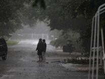 Heavy rain was pouring across much of Florida early Thursday as Andrea, the first tropical storm of the Atlantic hurricane season, headed toward the state's western coast and a new tropical storm warning was issued for a swath of the U.S. East Coast. (Photo: People stand near downed branches as Tropical Storm Isaac lashed the Florida Keys in August 2012).