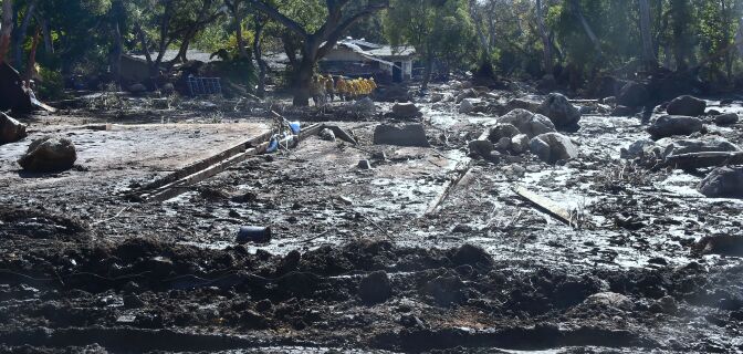 A search and rescue team make their way up a mud covered hillside in Montecito, California on January 12, 2018.
Heavy rains on January 9 sent rivers of waist-high mud and debris flowing from the hills into Montecito and other towns in Santa Barbara County northwest of Los Angeles, which are still recovering from last month's ferocious wildfires. At least 17 people died and dozens of residents are still unaccounted for. / AFP PHOTO / FREDERIC J. BROWN        (Photo credit should read FREDERIC J. BROWN/AFP/Getty Images)