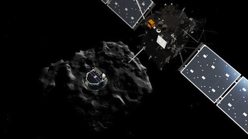 The Rosetta spacecraft, upper right, deploys a lander onto the surface of comet 67P, in background at center.