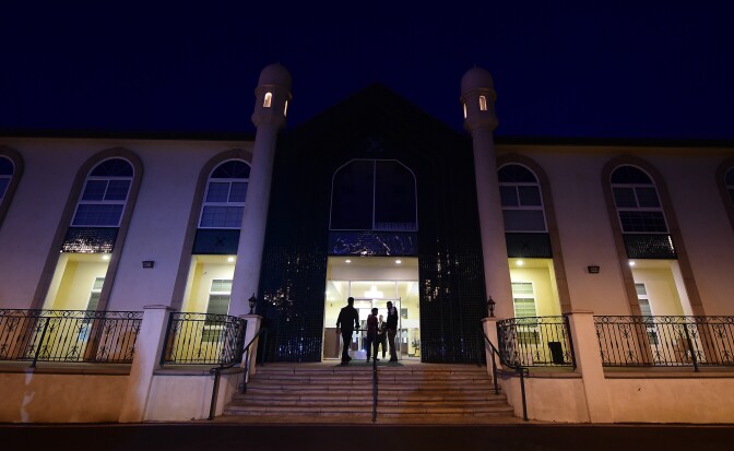People arrive at the Ahmadiyya Muslim Community in Chino, California on December 3, 2015, for prayers at the Baitul Hameed Mosque to commemorate lives lost a day after the tragedy in San Bernardino. 