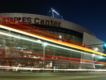 Vehicles pass by a darkened Staples Center on October 10, 2011.