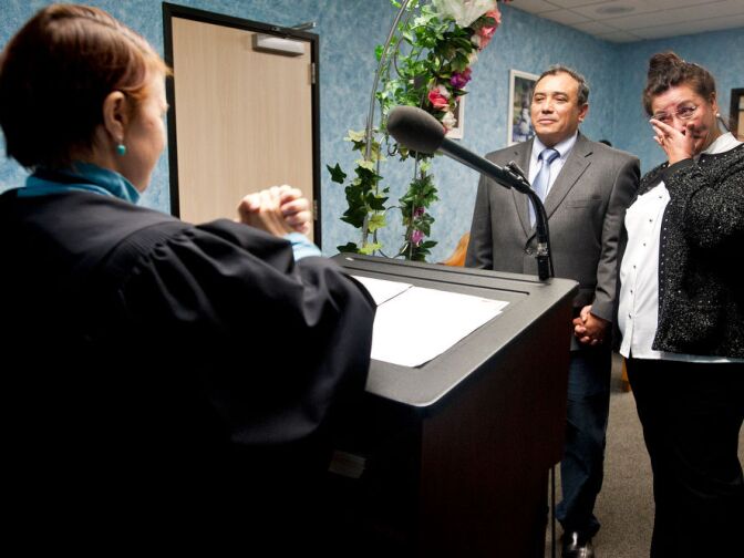 Elizabeth Oakes marries Louis Martin Cardo, 58, left, and Maria Elena Benson, 51, during an emotional ceremony.